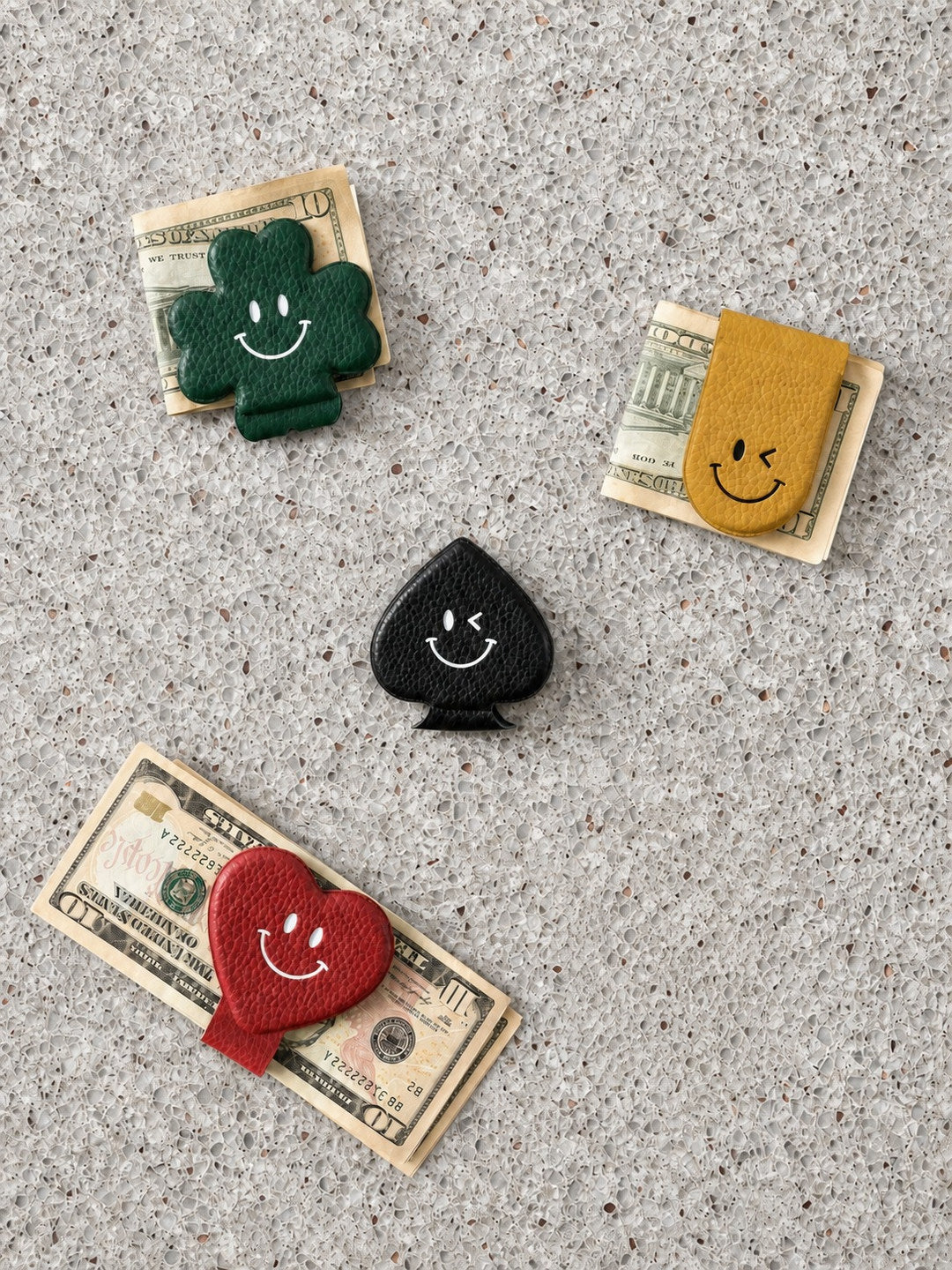 Colorful magnetic money clips holding folded bills